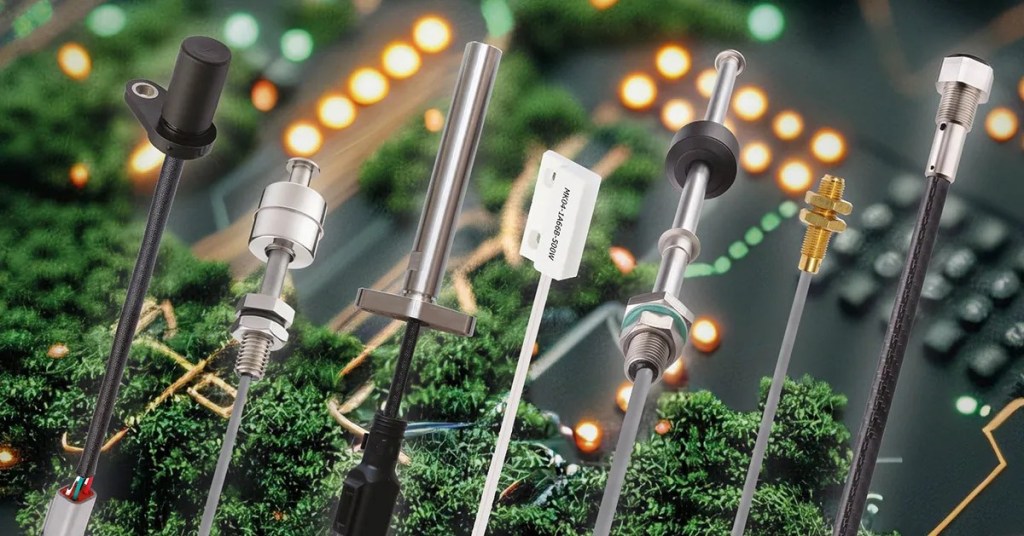 A variety of temperature sensors, probes, and a magnetic sensor are displayed vertically in front of a blurred circuit board background with glowing lights and green components. by Standex Detect