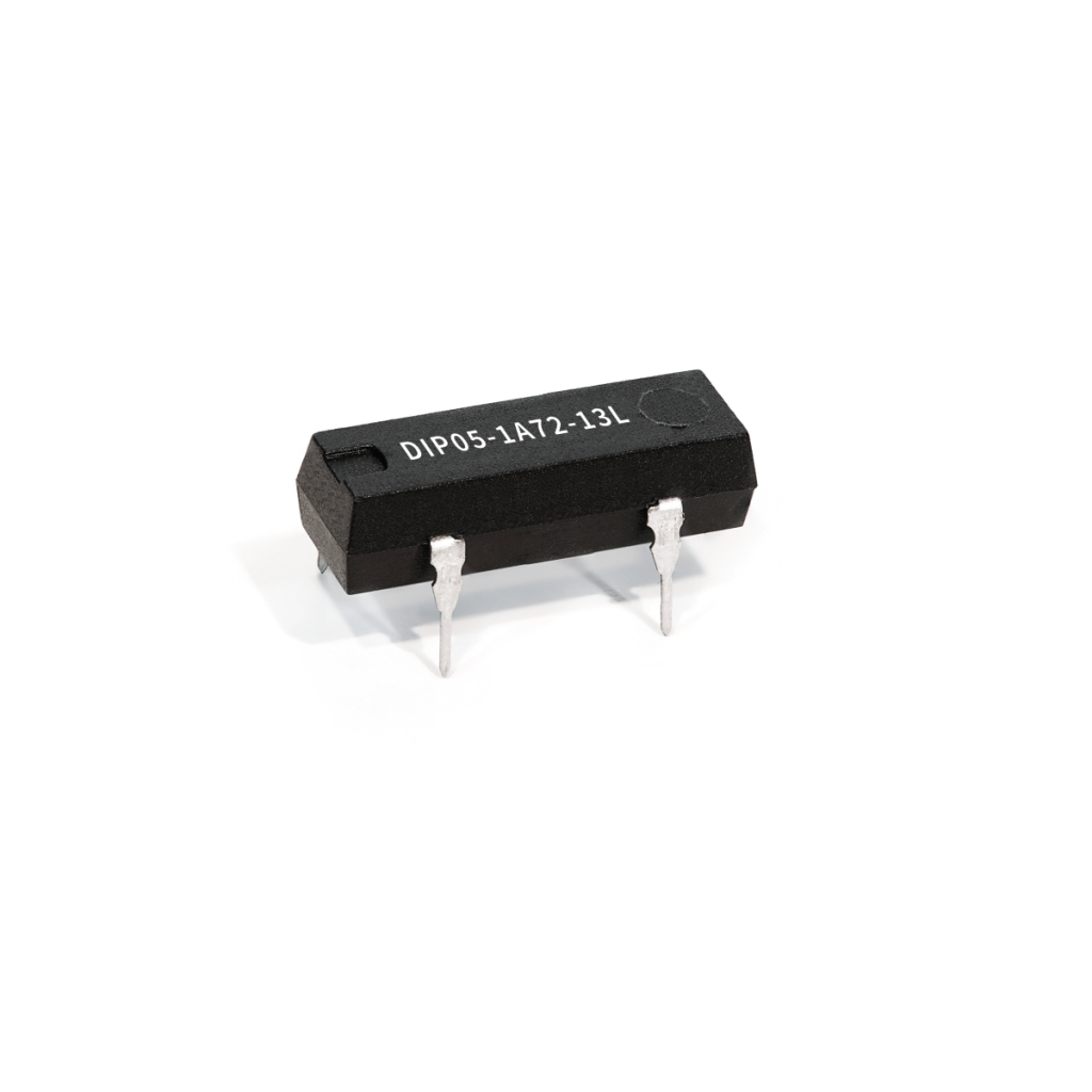 A black, rectangular Reed Relay electronic component with four metal pins, labeled DIP05-1A72-13L, isolated on a white background. by Standex Detect