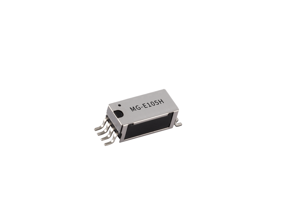A small M Series electronic component with six metal pins and MG-E105H labeled on its top surface, this Reed Relay is isolated on a white background. by Standex Detect