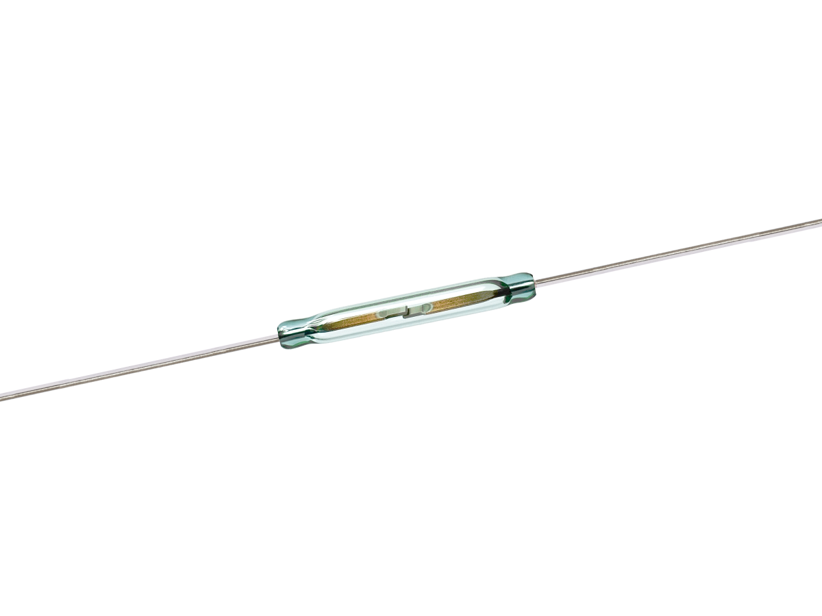 A cylindrical glass ORD2210 Series Reed Switch with two metal wires extending from each end, shown on a white background. The switch’s inner contacts are visible through the transparent casing. by Standex Detect